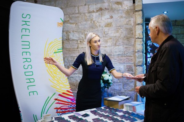 Portia welcoming a guest to the Skelmersdale Ambassadors event