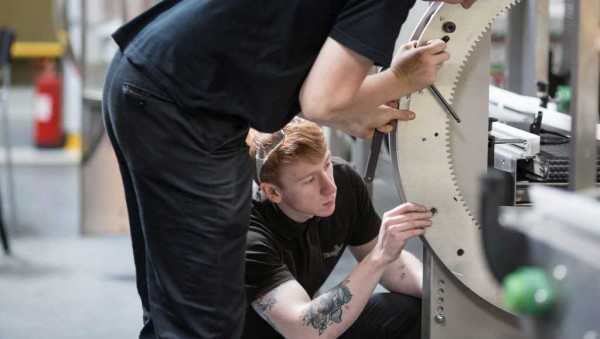 TrakRap employees working on machinery