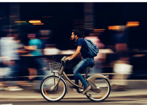 Man on bike Man riding a bike through a busy street